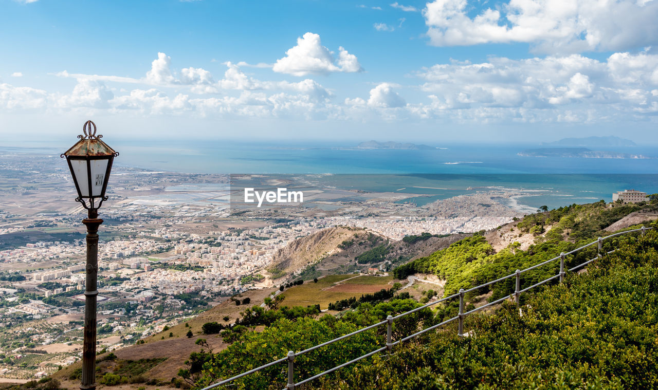 Scenic view of landscape by sea against sky