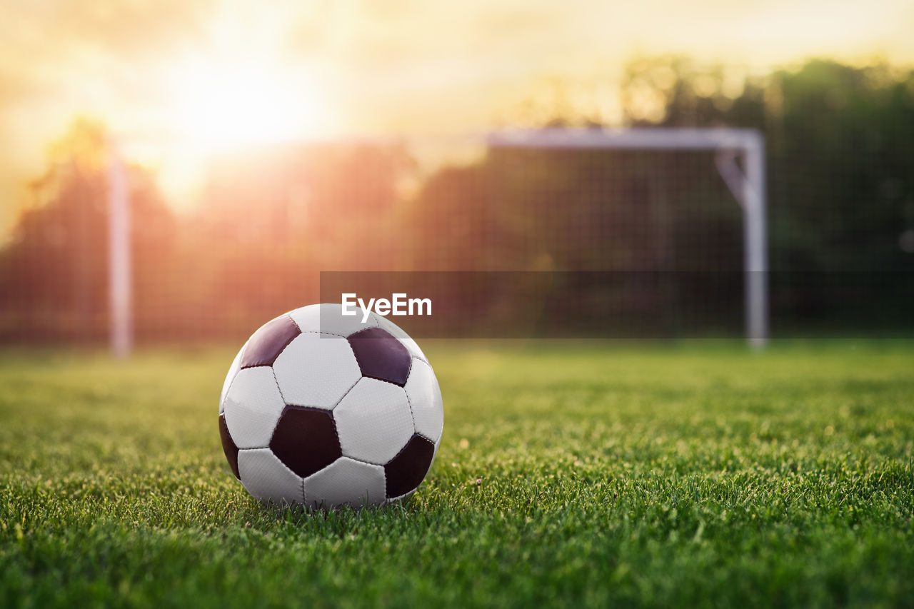 SURFACE LEVEL OF SOCCER BALL ON FIELD AGAINST SUNLIGHT