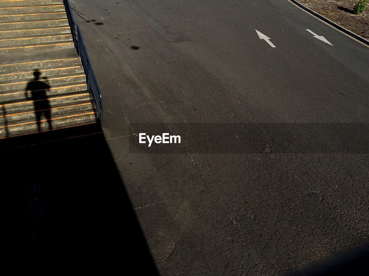 Highway with shadow of person on steps