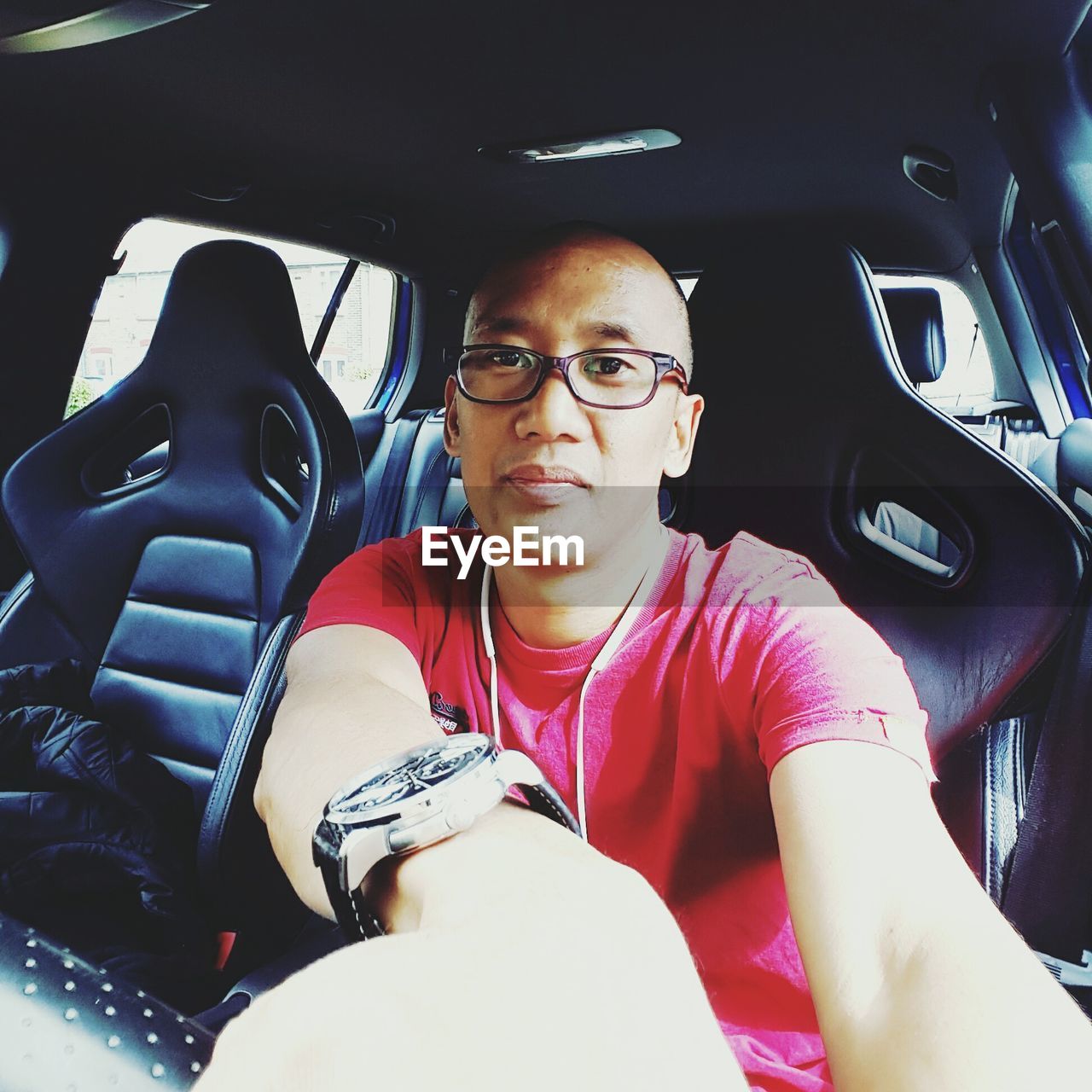 PORTRAIT OF WOMAN SITTING IN CAR