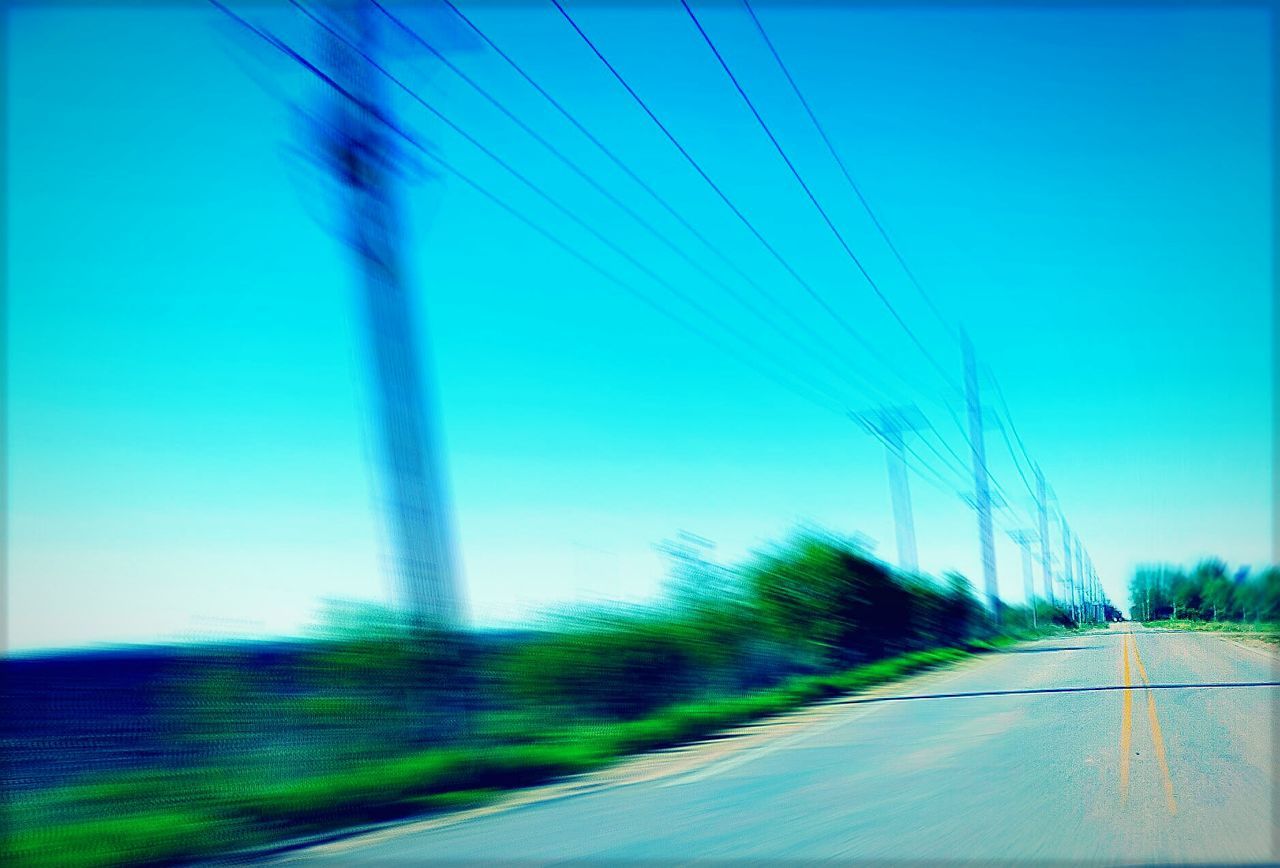 VIEW OF COUNTRY ROAD ALONG TREES