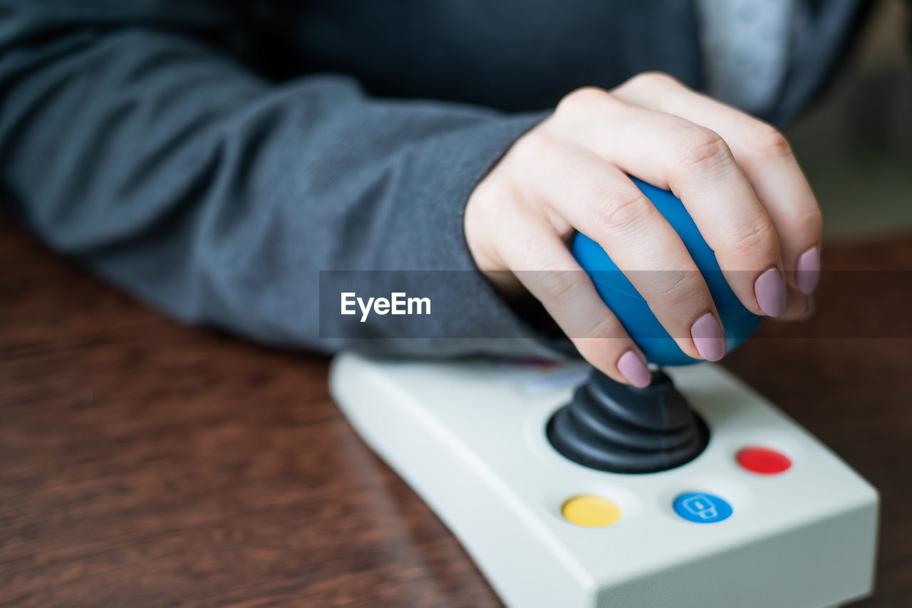 Close-up of person operating joystick