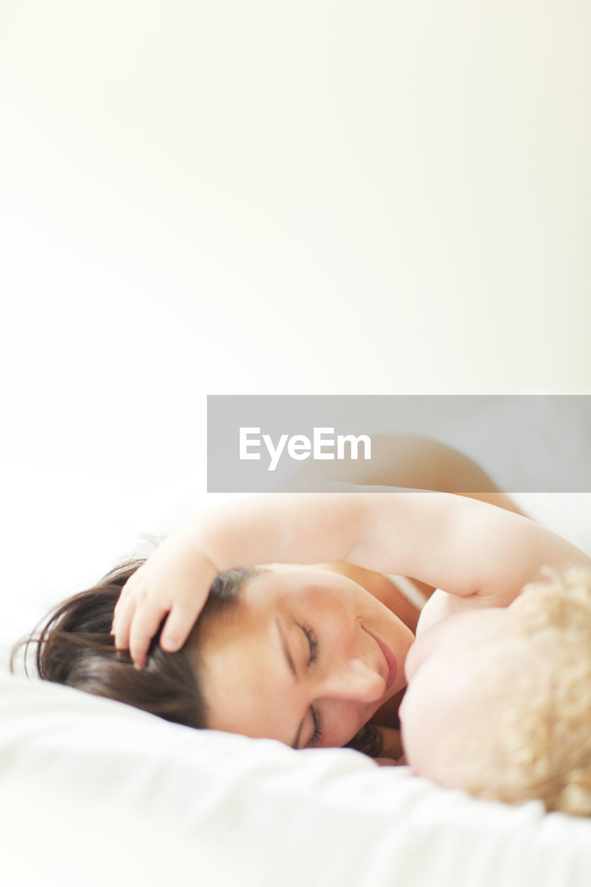 Mother with baby in bed, close-up