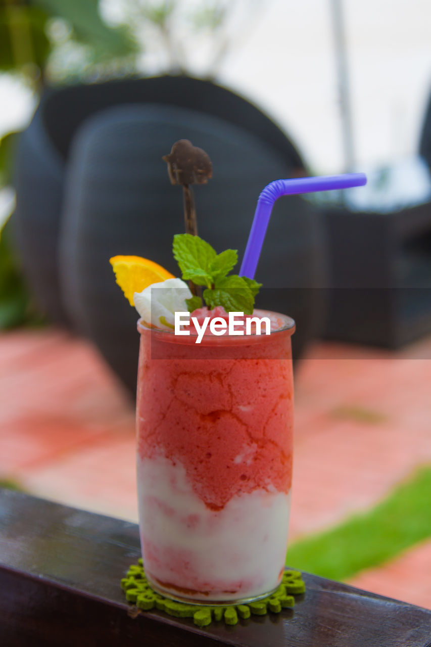 CLOSE-UP OF DRINK WITH GLASS OF JUICE