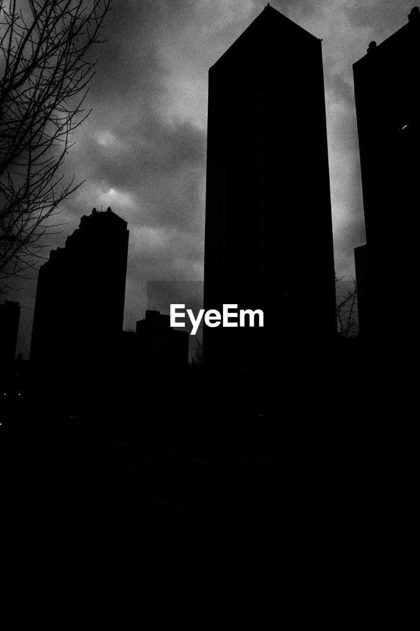 LOW ANGLE VIEW OF SILHOUETTE BUILDINGS AGAINST SKY DURING DUSK