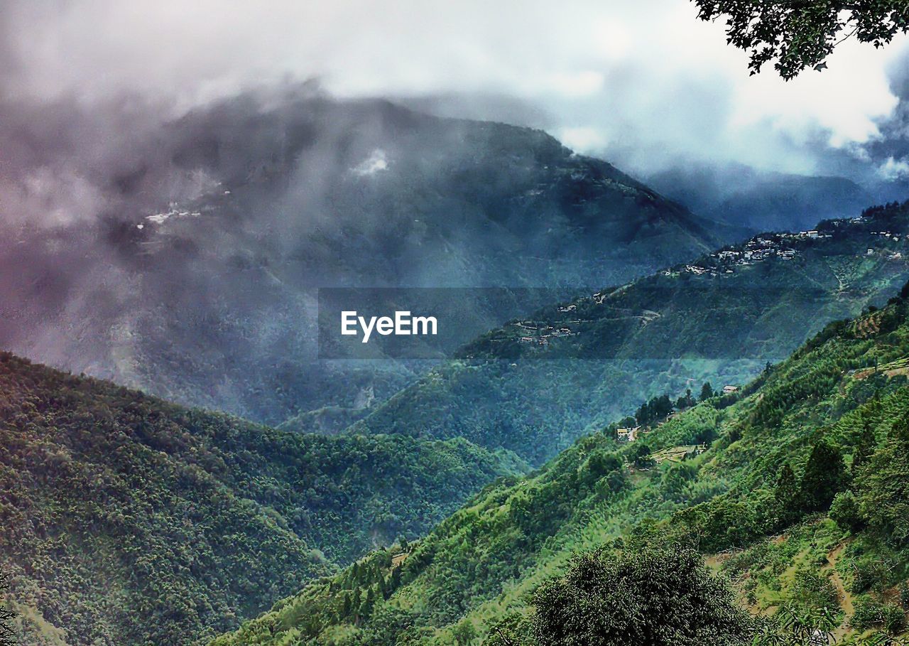 SCENIC VIEW OF LANDSCAPE AND MOUNTAINS AGAINST SKY