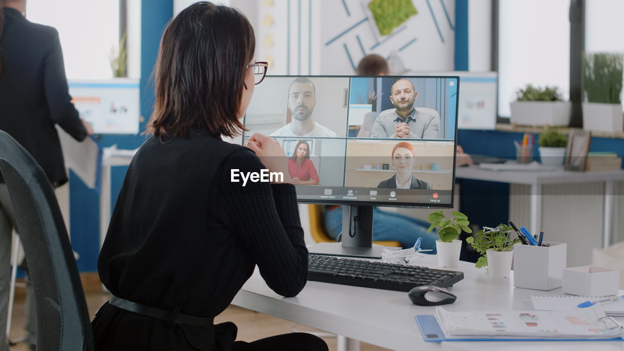 Businesswoman talking on video call at office