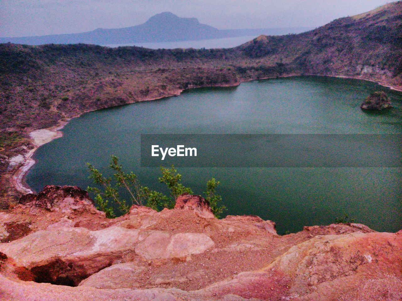 SCENIC VIEW OF SEA WITH MOUNTAIN IN BACKGROUND