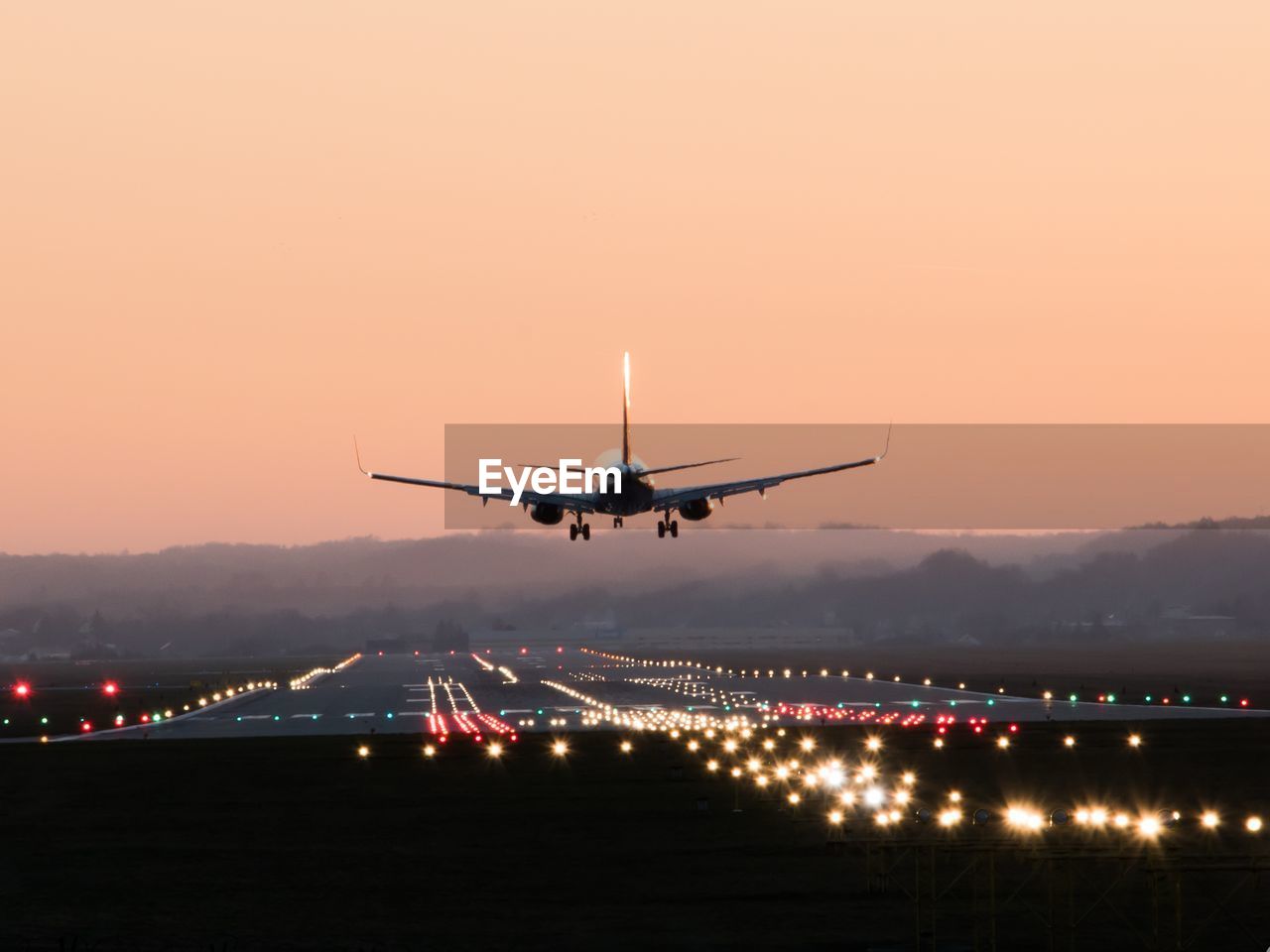 AIRPLANE IN SKY AT SUNSET