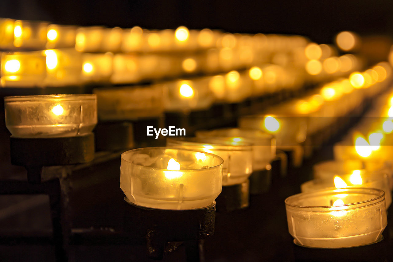 Lit tea light candles in church