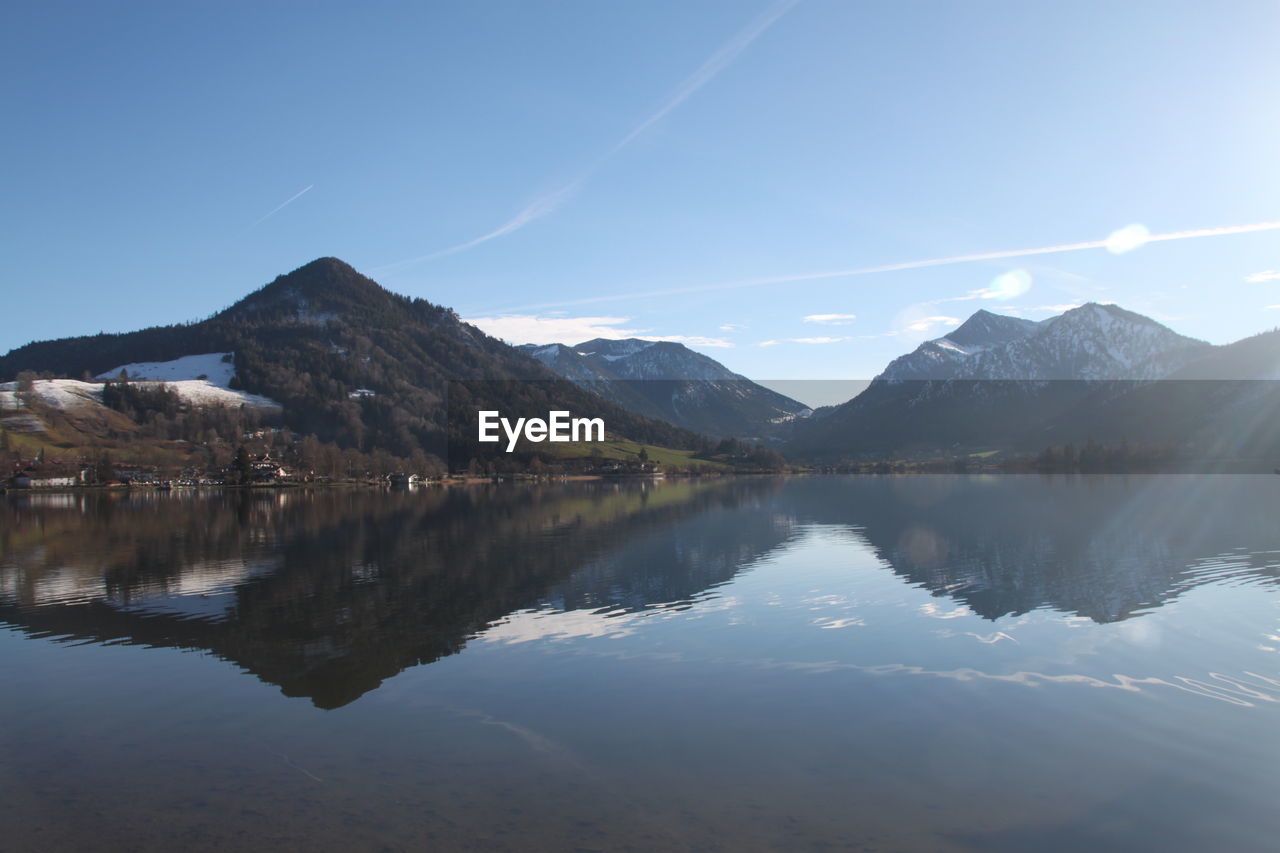 Scenic view of lake and mountains against sky