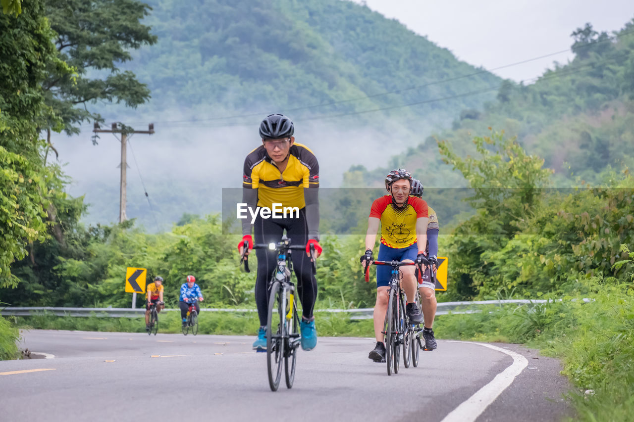 People riding bicycle on road