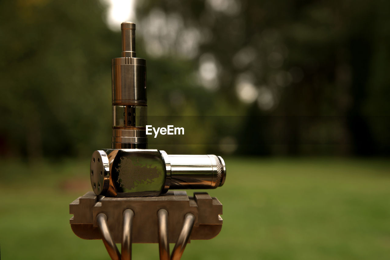 CLOSE-UP OF COIN-OPERATED BINOCULARS IN FIELD