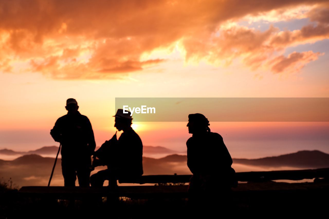 SILHOUETTE PEOPLE AGAINST ORANGE SKY DURING SUNSET