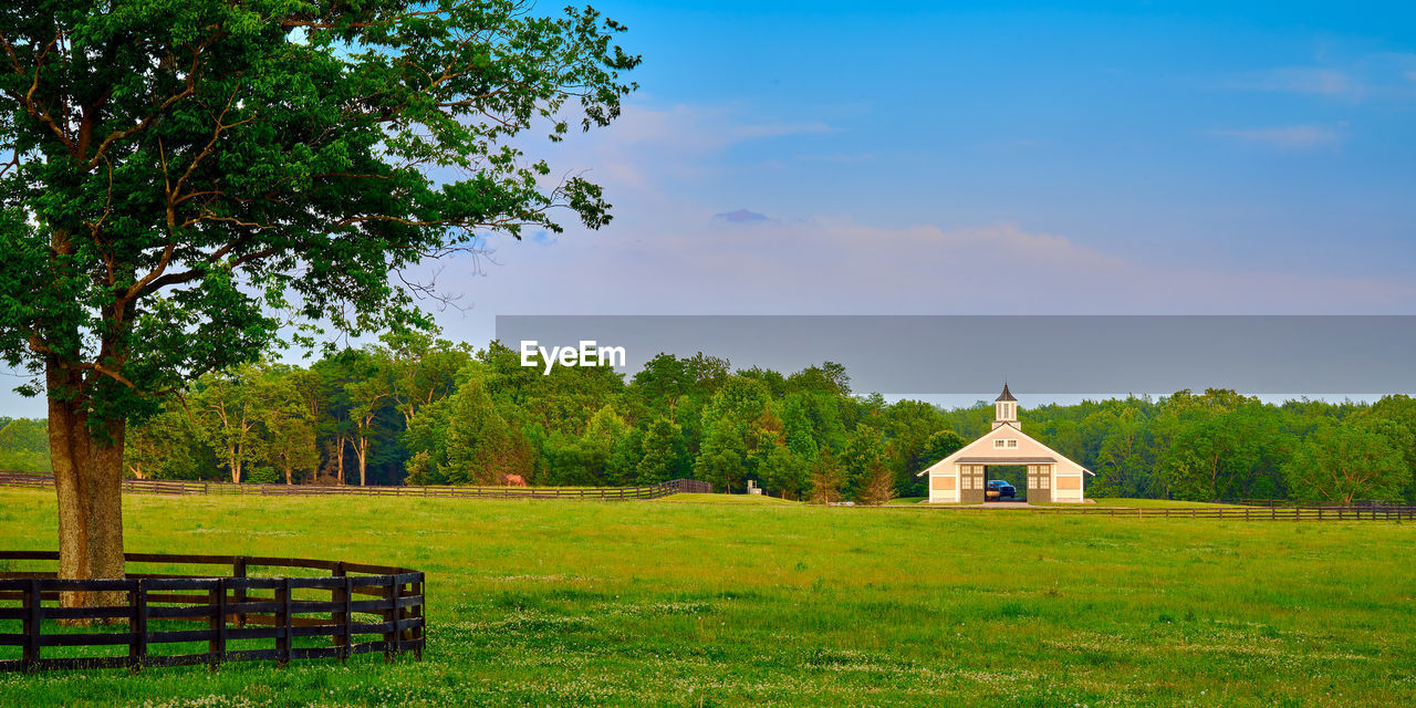 Kentucky horse barn with field in the foreground.