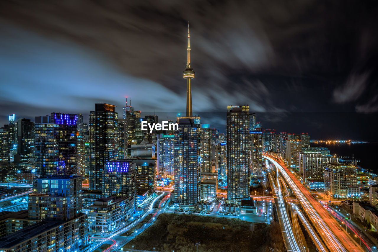 Illuminated cityscape against sky at night