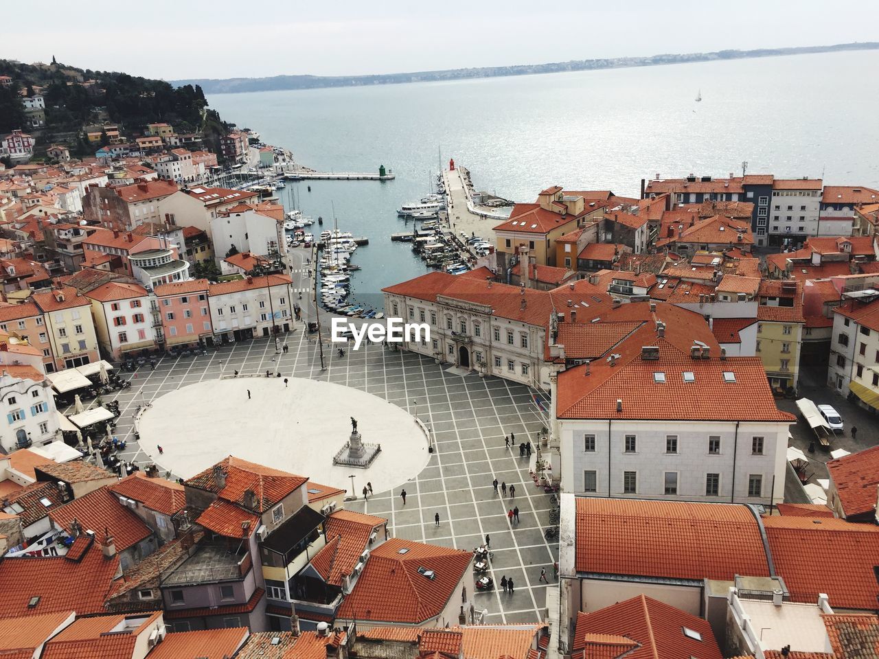 High angle view of townscape by sea against sky