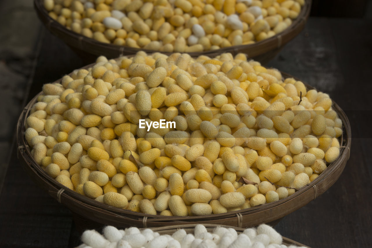 High angle view of silkworms cocoons for sale in baskets