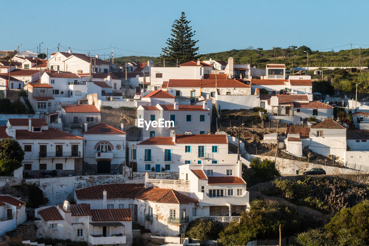 Houses in town against sky