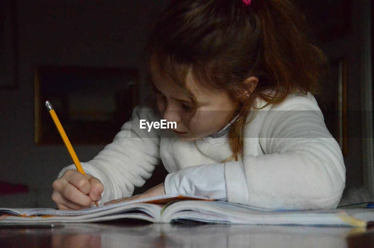 Girl doing homework at table