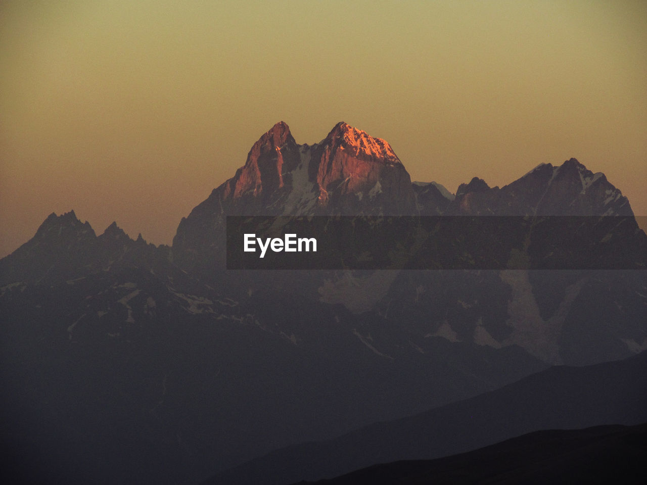 Rock formation against sky during sunset