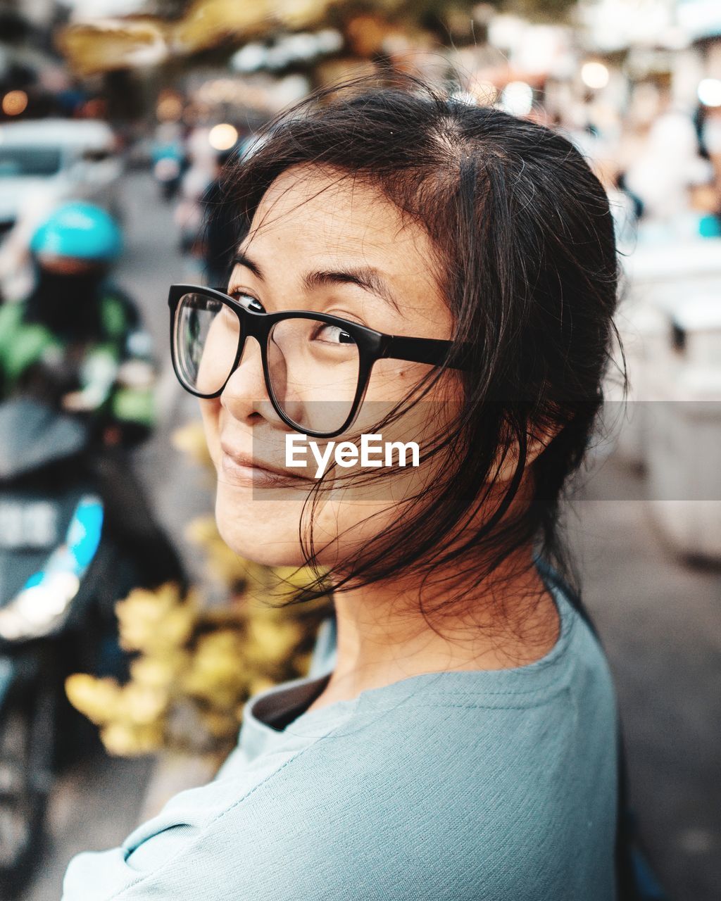 Portrait of smiling woman wearing eyeglasses on street