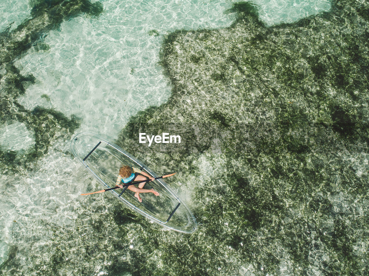 Aerial view of woman over inflatable boat in sea