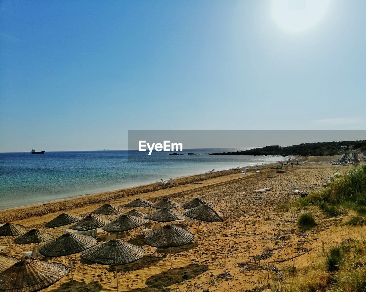 sky, sea, water, land, beach, horizon, ocean, body of water, shore, coast, nature, scenics - nature, beauty in nature, tranquility, wave, horizon over water, tranquil scene, sand, sunlight, clear sky, day, no people, blue, vacation, sunny, travel destinations, sun, travel, outdoors, rock, idyllic, bay, holiday, tourism, non-urban scene, environment, landscape, coastline, trip