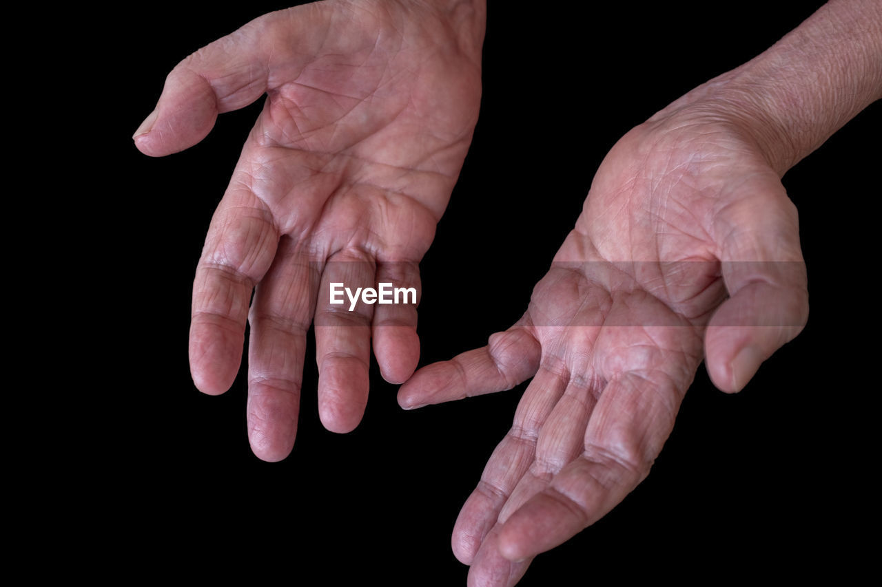 hand, black background, finger, adult, studio shot, senior adult, arm, healthcare and medicine, close-up, person, one person, wrinkled