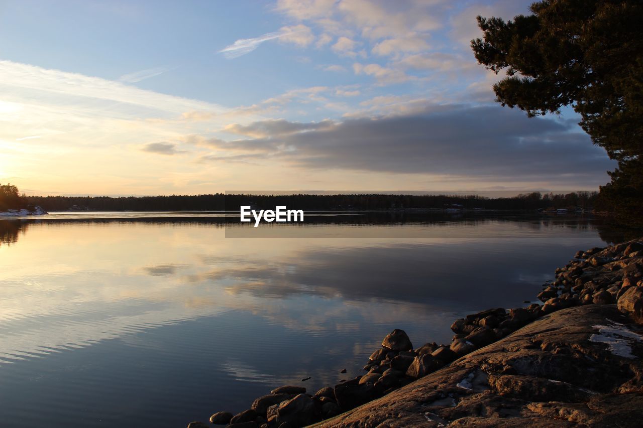 Scenic view of lake against sky during sunset