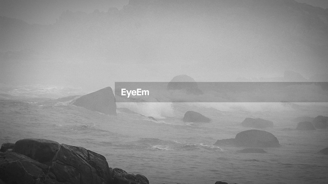 SCENIC VIEW OF SEA AND ROCK AGAINST SKY