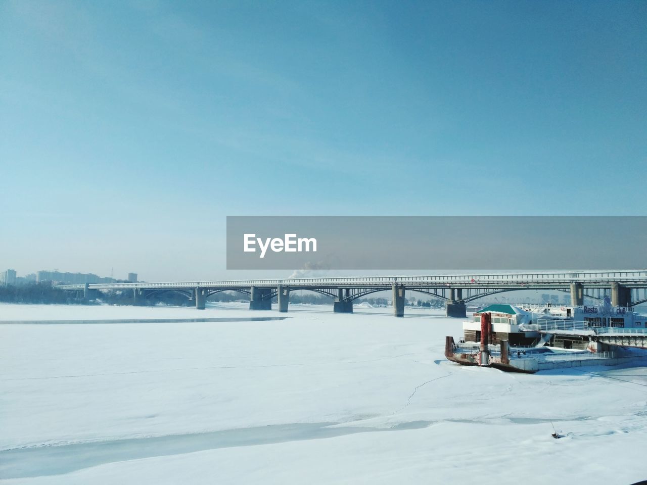 Bridge over river against sky during winter