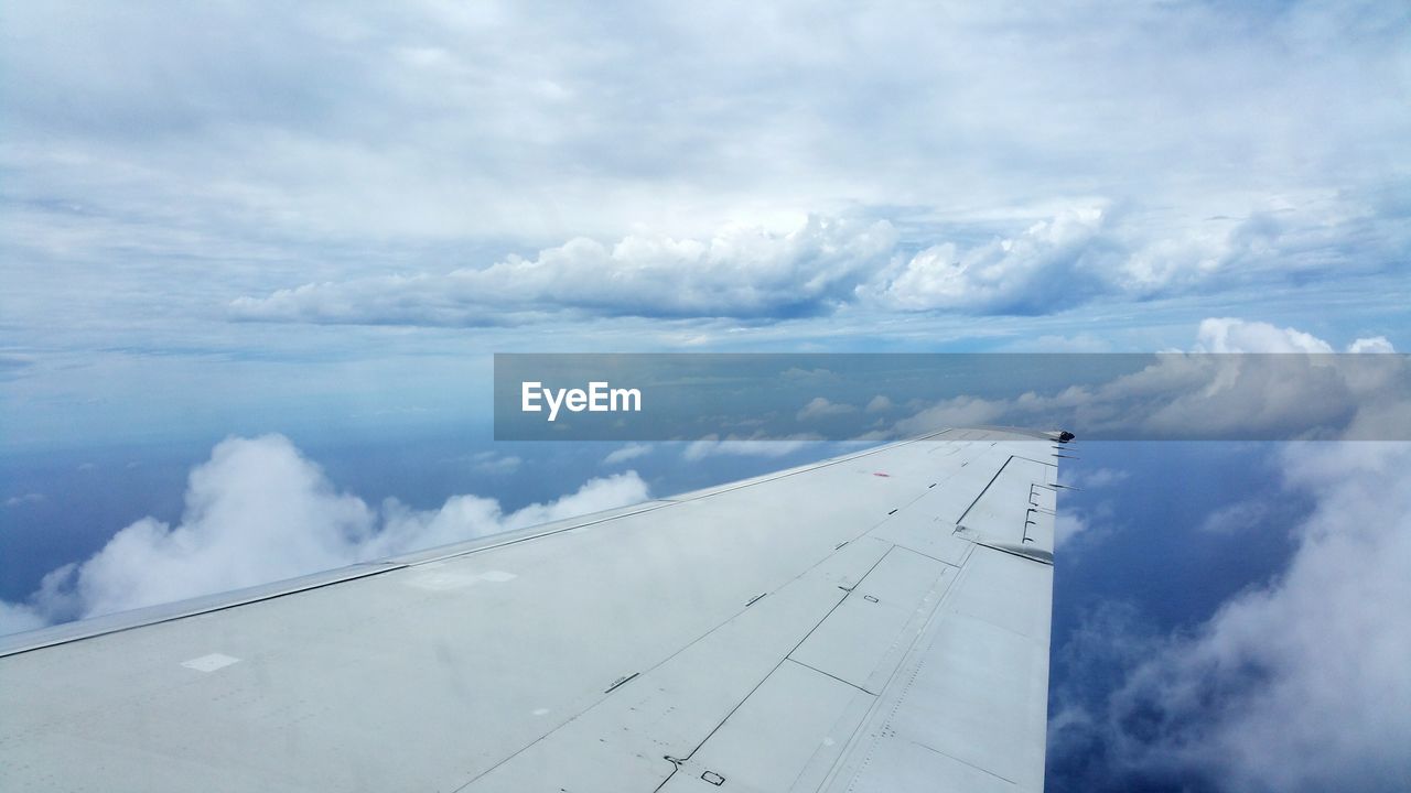 Aerial view of cloudscape over airplane wing