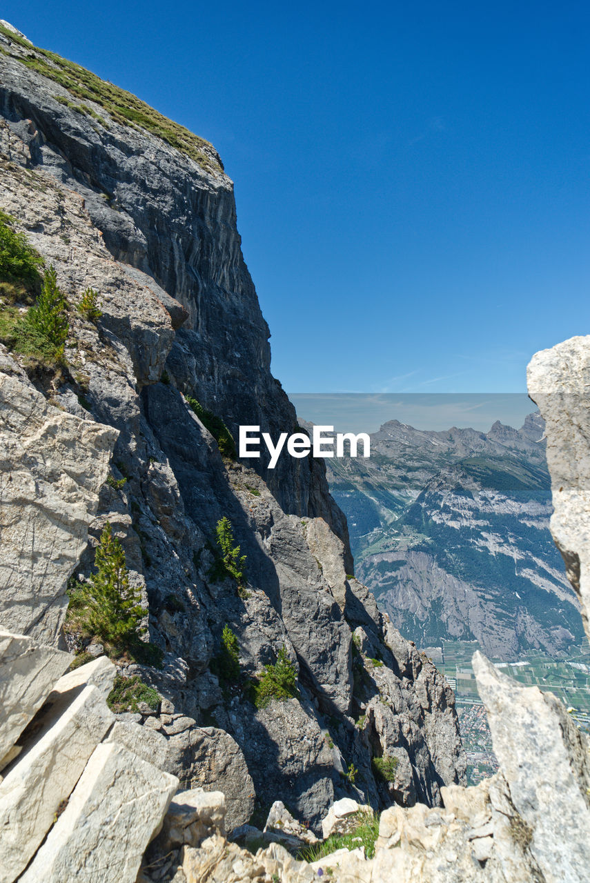 Scenic view of rocky mountains against clear blue sky