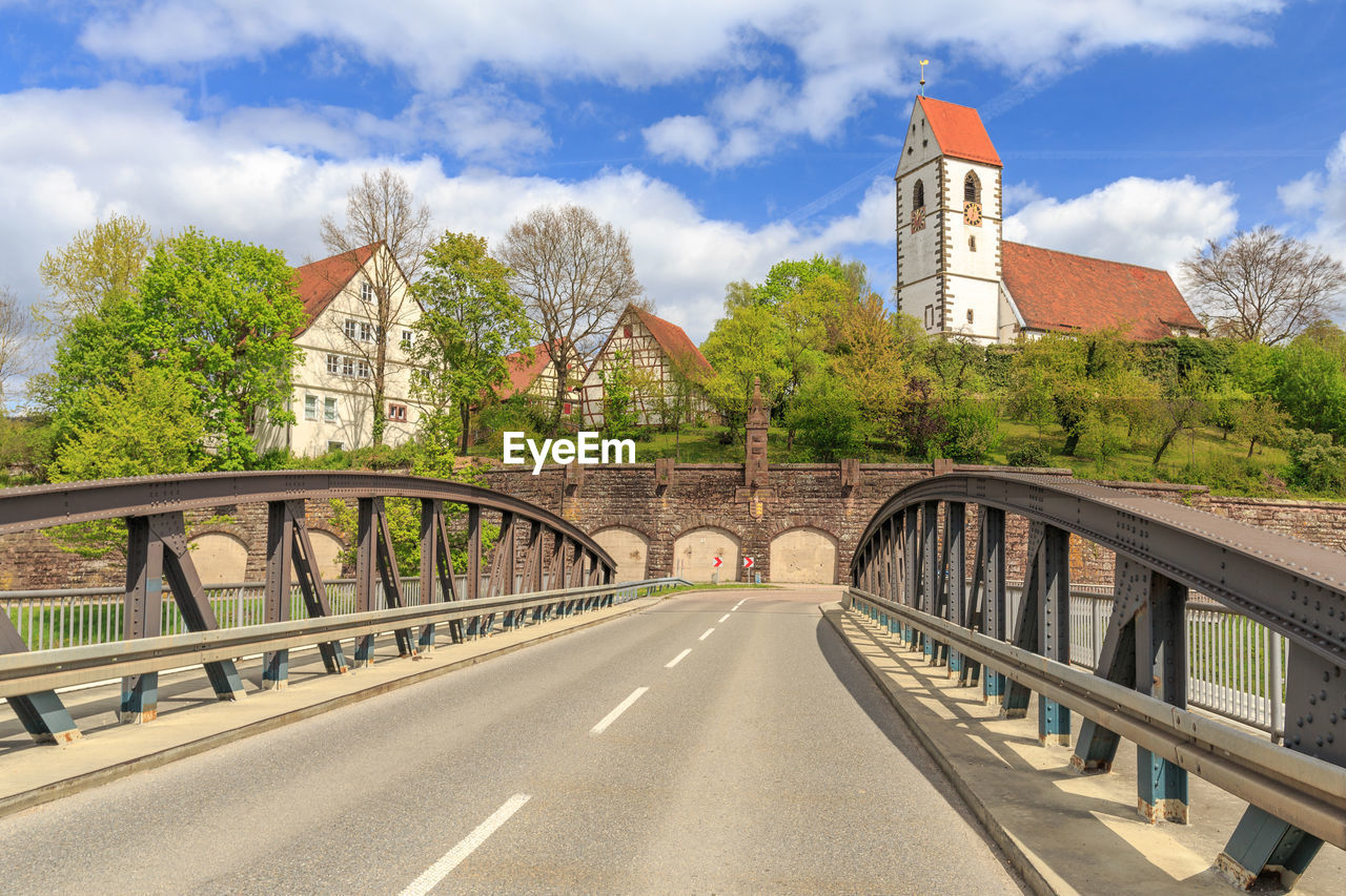 Bridge in city against sky