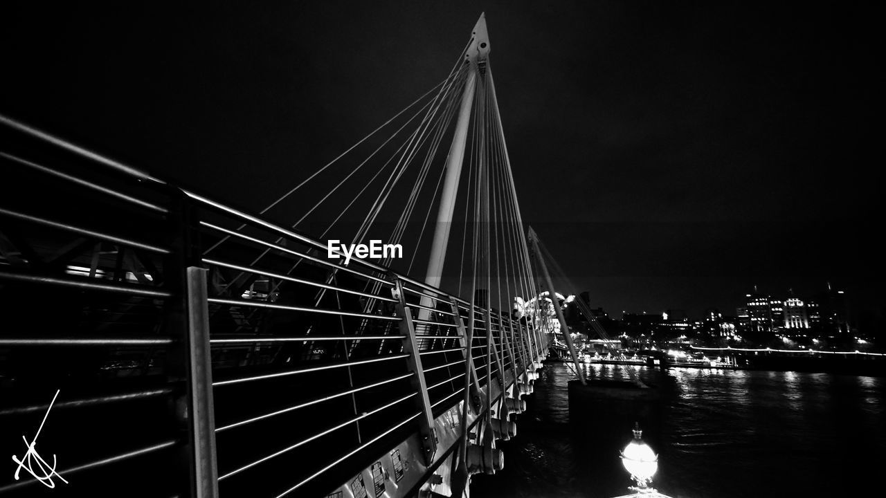 black and white, bridge, architecture, water, built structure, transportation, monochrome photography, darkness, night, monochrome, suspension bridge, sky, nature, light, city, travel destinations, illuminated, river, cable-stayed bridge, no people, building exterior, nautical vessel, mode of transportation, outdoors, travel, reflection, tourism