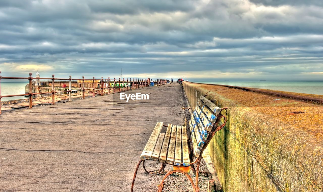 PIER ON BEACH AGAINST SKY