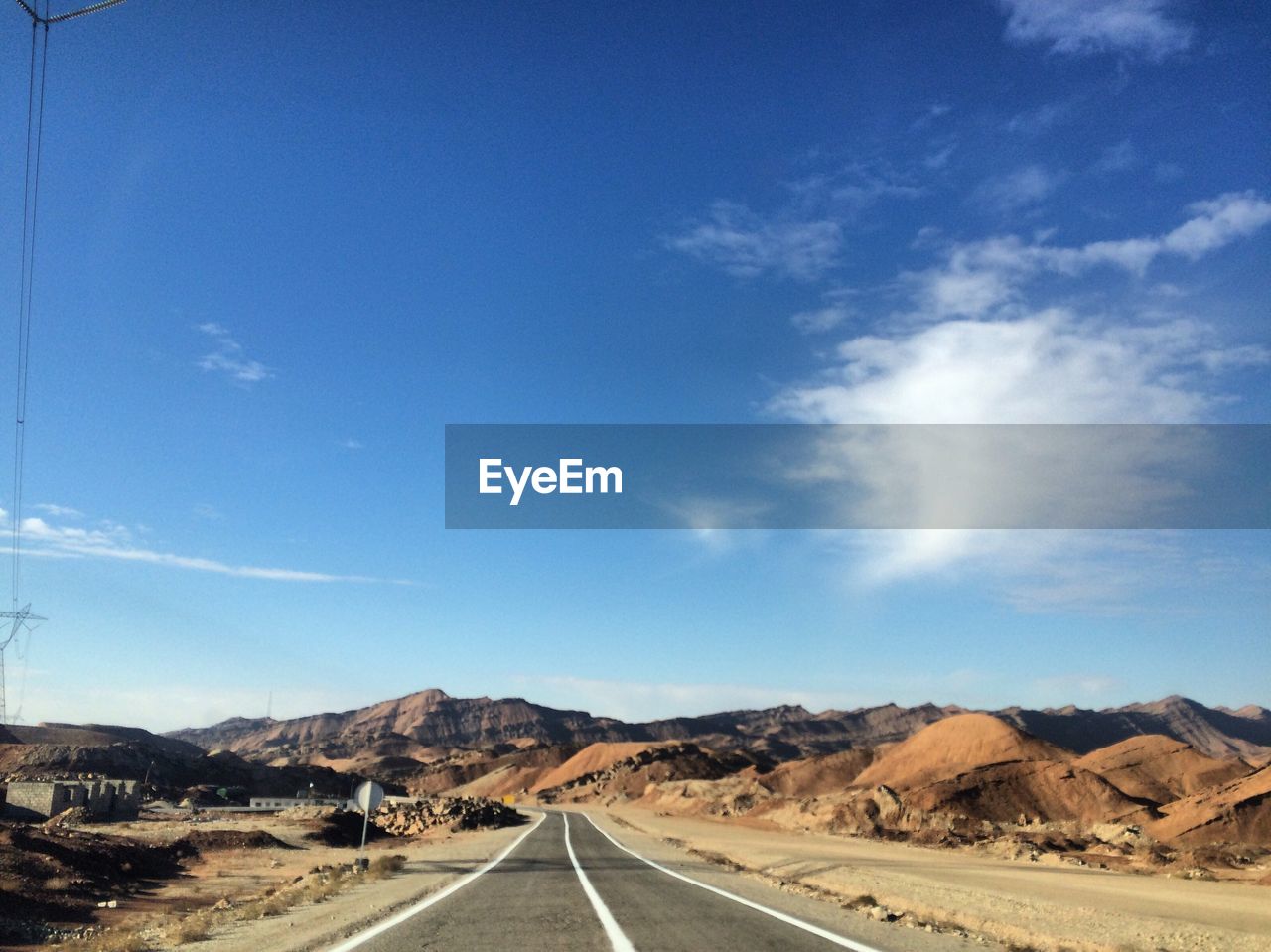 Road passing through landscape against sky