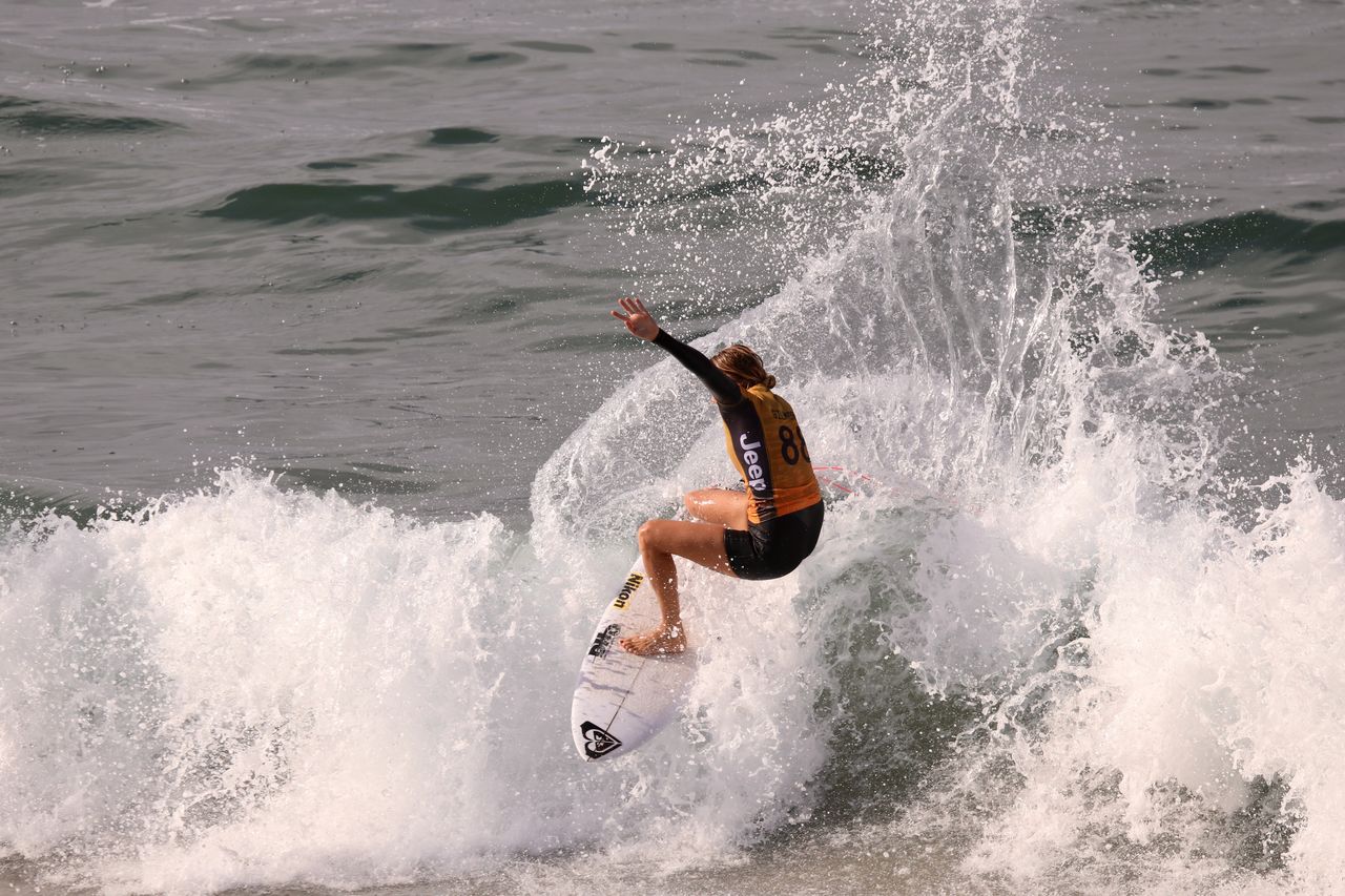 MAN SURFING ON SEA WAVES