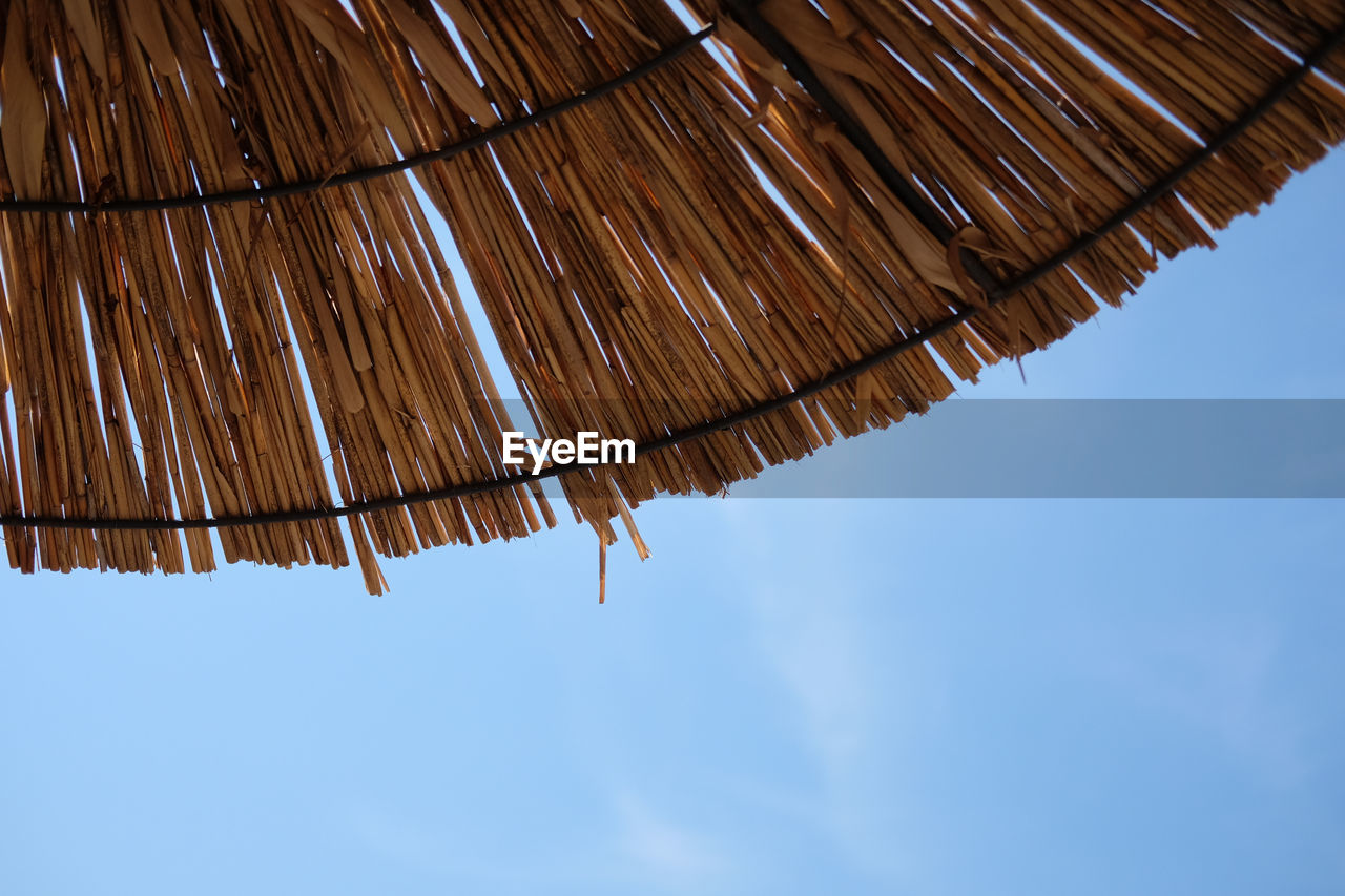 LOW ANGLE VIEW OF CLOTHES HANGING AGAINST SKY