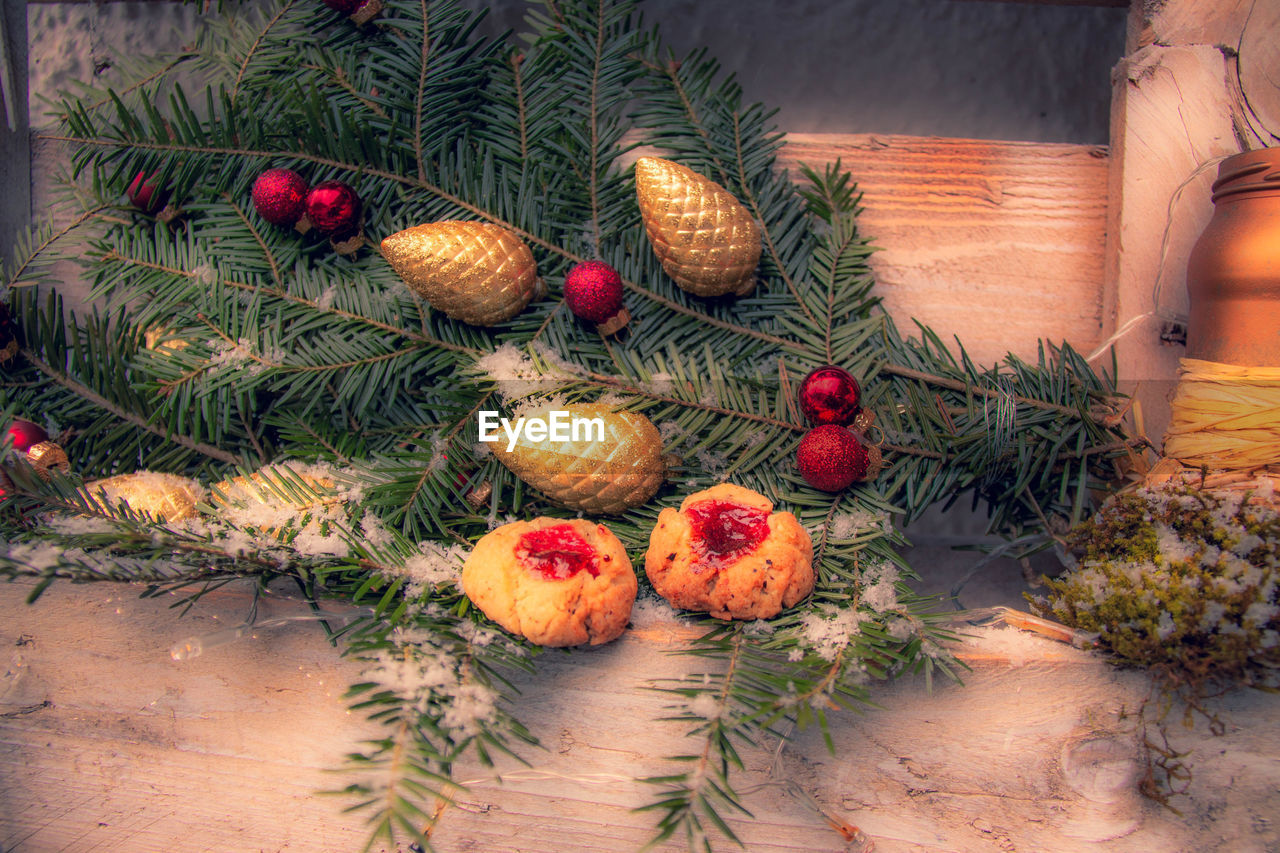 High angle view of cookies on christmas decoration on table