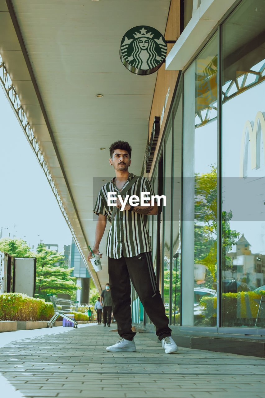 Low section of man walking on street