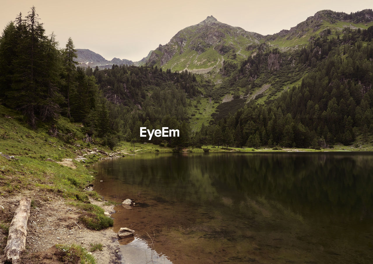 Scenic view of lake and mountains against sky