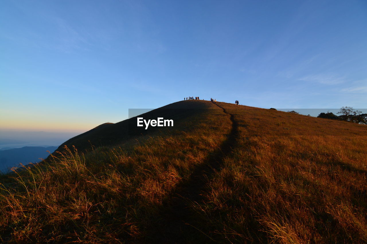 Scenic view of field and mountains against sky