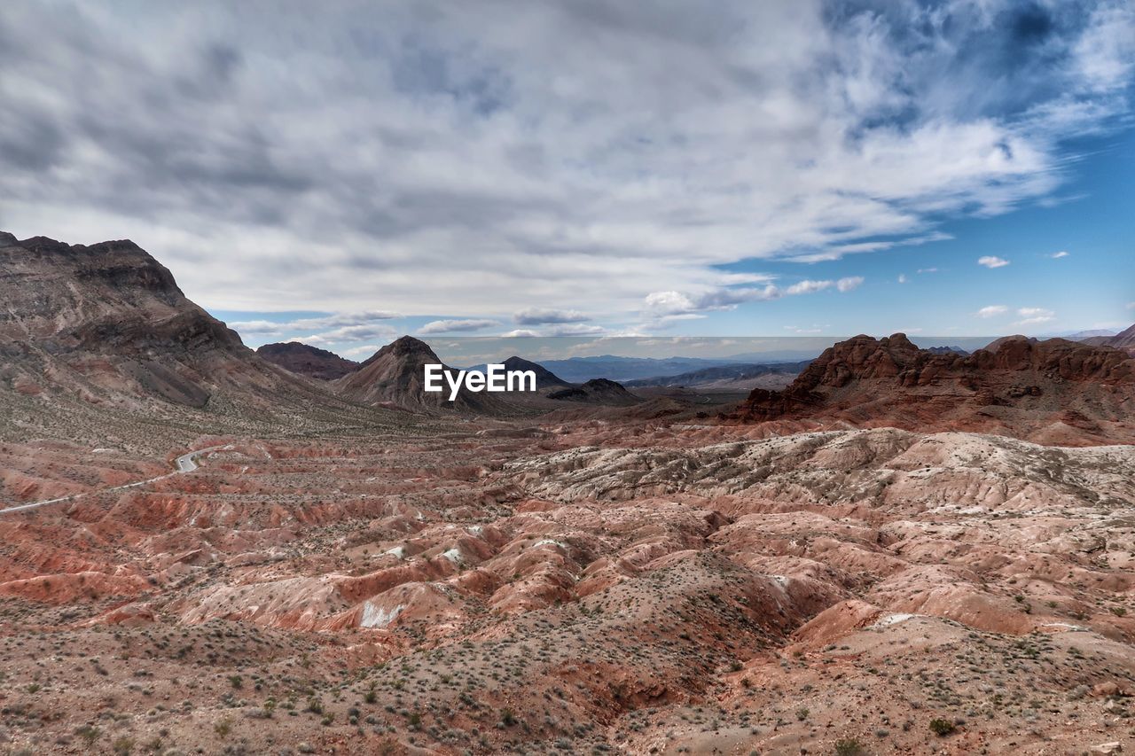 Scenic view of mountains against cloudy sky