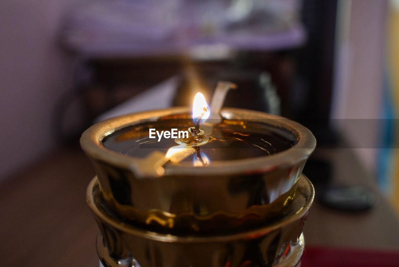 Close-up of lit tea light candles on table