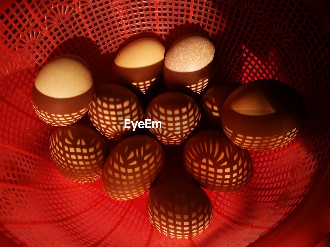 High angle view of chicken eggs in red container