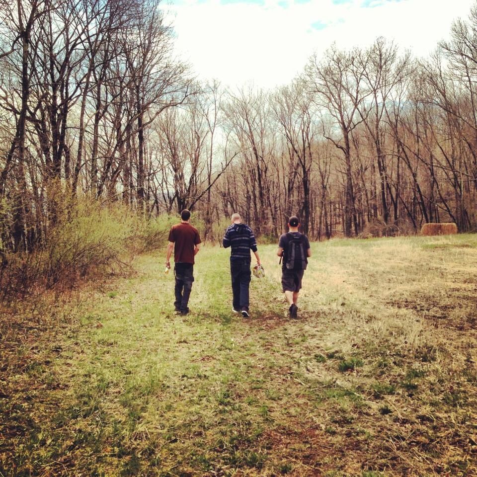 REAR VIEW OF PEOPLE WALKING ON LANDSCAPE