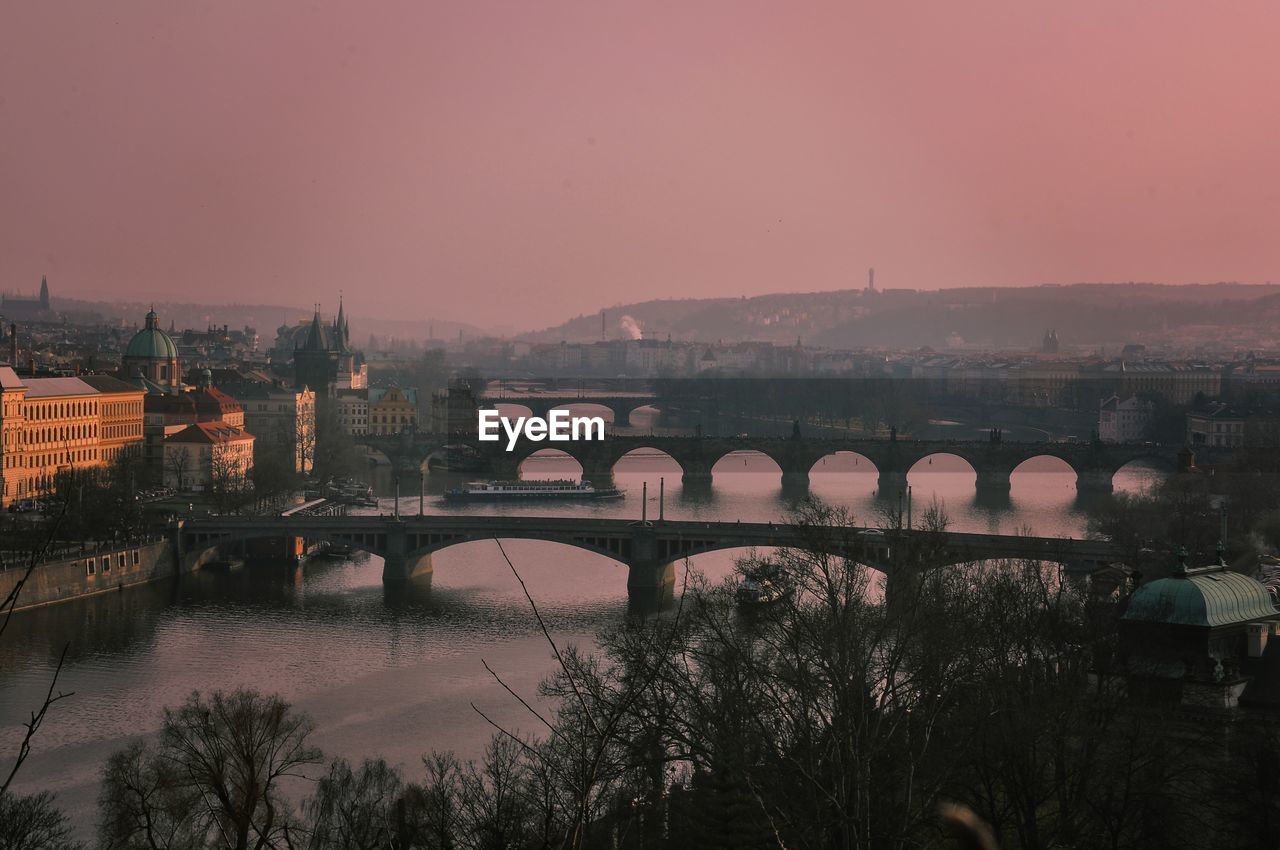 High angle view of arch bridges over vltava river against clear sky in city