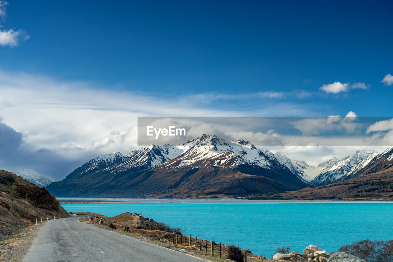Mount cook road alongside lake pukaki with snow capped southern alps in winter evening light. 